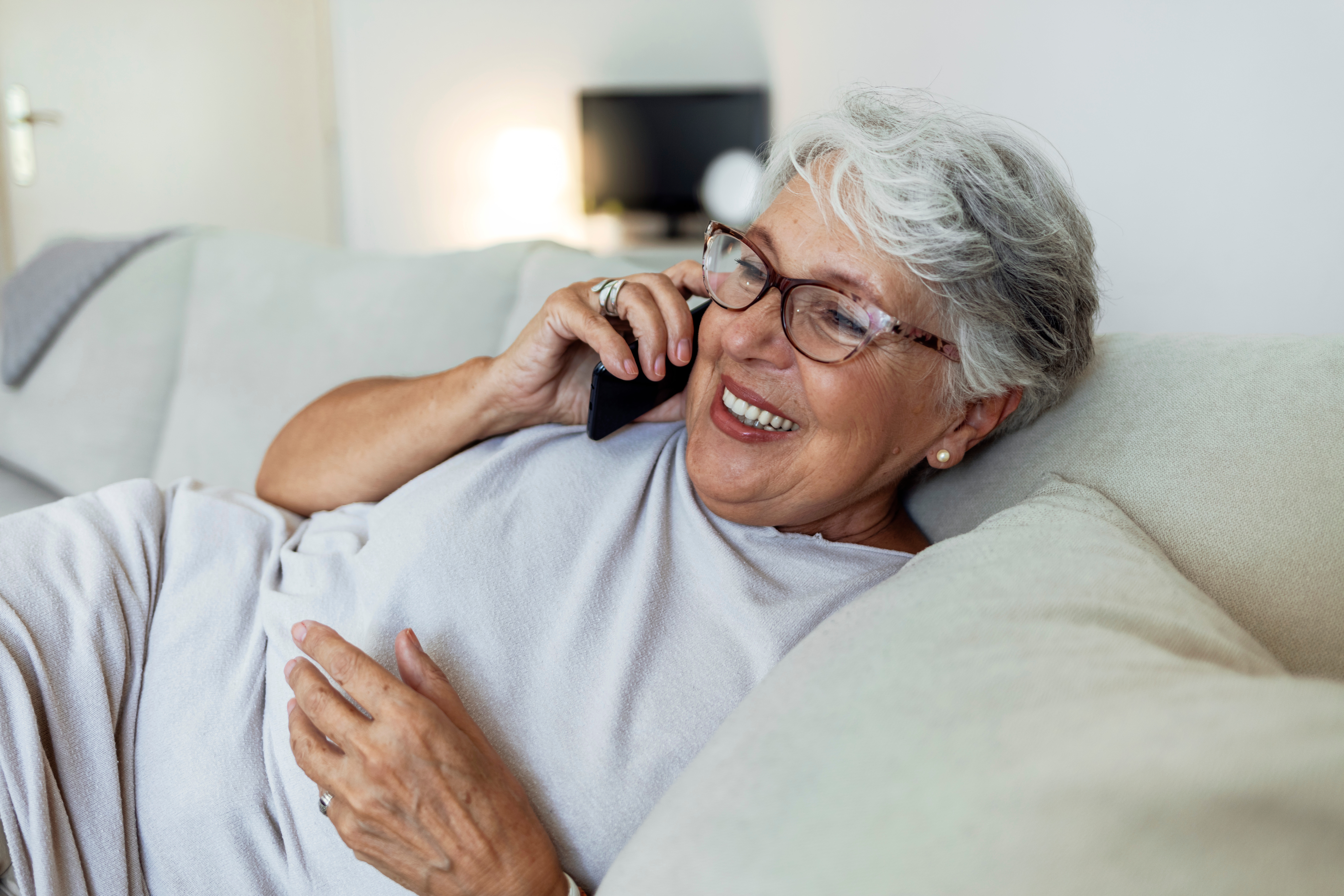 Older woman smiling while talking on the phone